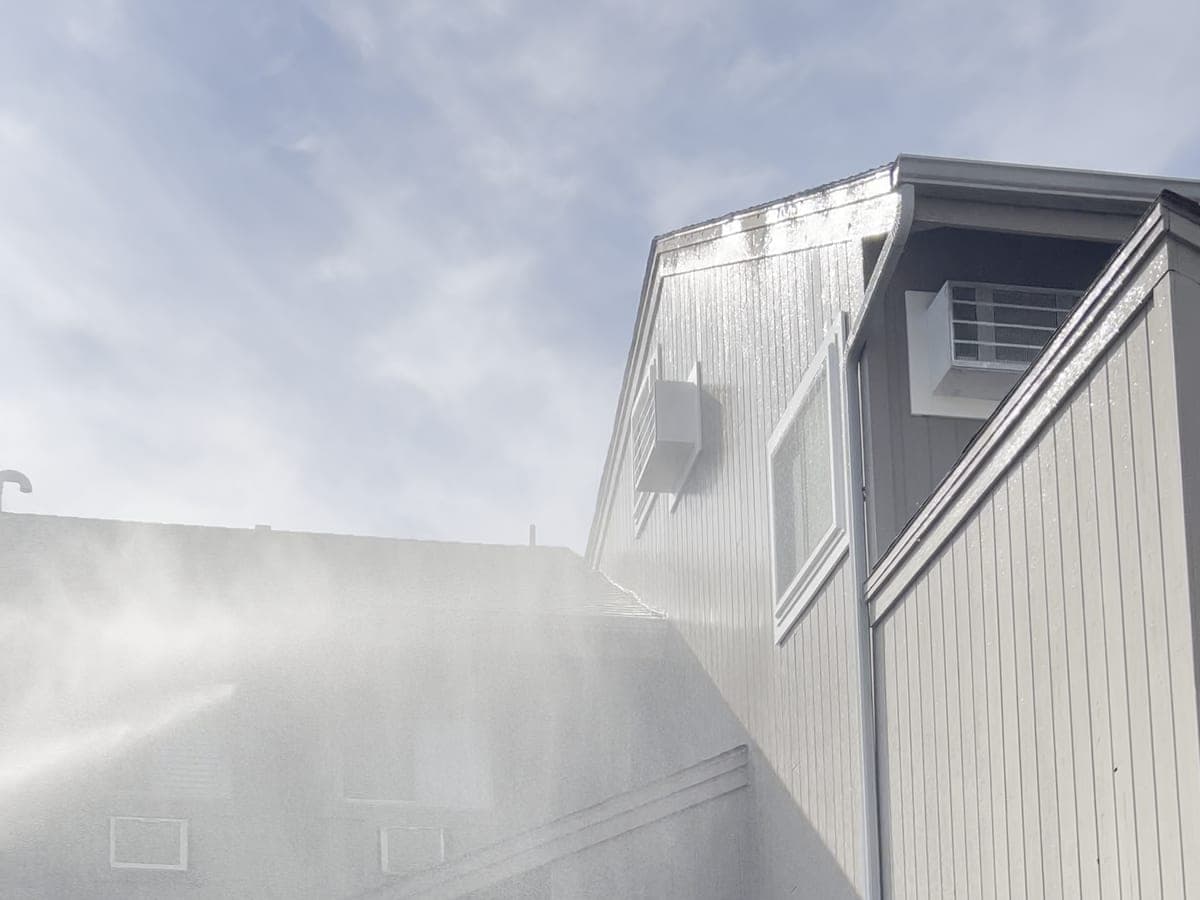 Wash water sheeting off the upper siding of an apartment elevation